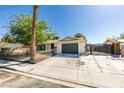 Charming single-story home with desert landscaping, driveway, and secure gated entry at 1304 Virgil St, Las Vegas, NV 89110