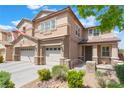 Charming two-story house with well-kept front yard, dual garage, and a welcoming entrance gate, under a clear blue sky at 150 Pocono Ranch Ave, North Las Vegas, NV 89031
