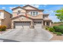 Two-story home with tandem three-car garage, neutral color, flags, and a well-maintained concrete driveway, and desert landscaping at 150 Pocono Ranch Ave, North Las Vegas, NV 89031