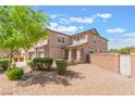Two-story house with neat landscaping, a side desert landscape, and a well-manicured lawn on a sunny day at 150 Pocono Ranch Ave, North Las Vegas, NV 89031