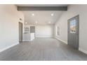 Spacious, light-filled living room with wood-look flooring, recessed lighting and modern finishes at 1720 Hassett Ave, Las Vegas, NV 89104