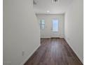 Bright entryway with wood-look flooring, white walls, and a frosted glass front door and window to the side at 2636 Lily Point St, Las Vegas, NV 89156