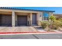 Attractive townhouse showcasing a convenient one-car garage and well-maintained landscaping at 2727 Chinaberry Hill St, Laughlin, NV 89029