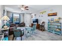 Bright living area with beach decor, ceiling fan, and tile floors for a cozy, coastal feel at 2727 Chinaberry Hill St, Laughlin, NV 89029