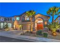Inviting two-story home with mature palms, decorative stone landscaping, and a spacious three-car garage at 2749 Carolina Blue Ave, Henderson, NV 89052