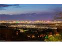 An evening skyline view showcases the distant Las Vegas Strip lights, offering a stunning backdrop from the property at 286 Shaded Canyon Dr, Henderson, NV 89012