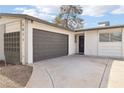 Single-story home featuring a two-car garage, desert landscaping, and a gray accent wall at 3017 Jamestown Way, Las Vegas, NV 89102