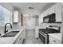Bright kitchen with modern appliances, white cabinets, and view to living area at 3404 Winterhaven St # 204, Las Vegas, NV 89108