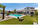 A stunning backyard featuring a sparkling pool, lush lawn, and inviting outdoor living spaces at 3458 W Agate Ave, Las Vegas, NV 89139