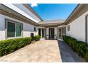A charming courtyard entrance with elegant landscaping and a welcoming front door at 3458 W Agate Ave, Las Vegas, NV 89139