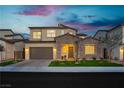 Beautiful two-story home featuring a stone facade, manicured lawn, and a spacious two-car garage at 350 Gandara St, Las Vegas, NV 89138