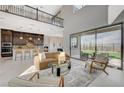 Bright open-concept living room featuring high ceilings, natural light, and backyard access at 350 Gandara St, Las Vegas, NV 89138