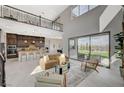 Bright, open-concept living room features soaring ceilings, natural light, and access to the backyard at 350 Gandara St, Las Vegas, NV 89138