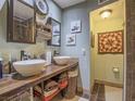 Rustic bathroom with dual vessel sinks, wooden countertop, and decorative accents at 438 Las Casitas Way, Las Vegas, NV 89121