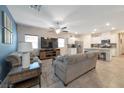 Bright, open-concept living area with neutral tones, tile flooring, and ceiling fan for added comfort at 4505 Meline Ave, North Las Vegas, NV 89084