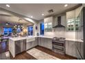 Well-lit kitchen featuring stainless steel appliances, white cabinets, and hardwood floors at 47 Strada Principale, Henderson, NV 89011