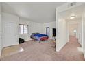 Bright bedroom featuring neutral decor, carpeting, a double bed, and easy access to the hallway at 5250 S Rainbow Blvd # 1144, Las Vegas, NV 89118