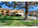 Well-manicured lawn and landscaping complement this inviting single-story home with a two-car garage at 5541 Port Barrington Way, Las Vegas, NV 89130