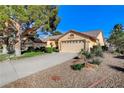 A single-story home with desert landscaping and a spacious driveway leading to a two-car garage at 5541 Port Barrington Way, Las Vegas, NV 89130