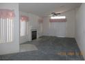 Bright living room with high ceilings, fireplace, carpet, and a large window at 5912 Wabusca Way, Las Vegas, NV 89142