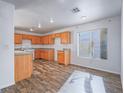 Charming kitchen features wood cabinets, a white gas stove, and light hardwood flooring at 5929 Sleepy Fawn Dr, Las Vegas, NV 89142