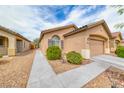 Well-kept single story home with desert landscaping and a two car garage and beautiful desert plants at 6116 Tokara Ave, Las Vegas, NV 89122
