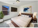 Cozy bedroom with modern decor, a large window, and stylish furnishings at 7011 Overton St, Las Vegas, NV 89166