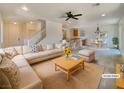 Bright and airy living room featuring an open floor plan, neutral decor, and lots of natural light at 7011 Overton St, Las Vegas, NV 89166