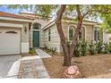 Close up of a charming home featuring a decorative front door, desert landscaping, and tiled entryway at 7716 Twin Tails St, Las Vegas, NV 89149