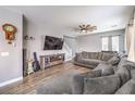 Spacious living room with hardwood floors, grey walls, large windows, and a comfortable sectional couch at 7898 Red Rock Ridge Ave, Las Vegas, NV 89179
