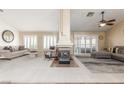 Large and bright living room with fireplace, neutral decor, and plantation shutters at 805 Blue Springs Dr, Henderson, NV 89002