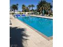 Beautiful outdoor pool surrounded by lounge chairs and palm trees, perfect for relaxation at 8255 Las Vegas Blvd # 405, Las Vegas, NV 89123