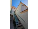 Exterior stairway with blue railing leading to the entrance of the home at 8452 Boseck Dr # 216, Las Vegas, NV 89145