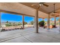 Large covered patio featuring ceiling fans, columns, and an amazing backyard view at 931 Temple View Dr, Las Vegas, NV 89110