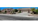 Inviting house with a spacious driveway and well-maintained desert landscaping at 931 Temple View Dr, Las Vegas, NV 89110