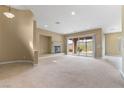 Spacious living room with a fireplace and sliding glass doors offering great views of the yard at 1111 Casa Palermo Cir, Henderson, NV 89011