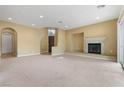 Bright living room featuring a fireplace, recessed lighting, and smooth carpet flooring at 1111 Casa Palermo Cir, Henderson, NV 89011