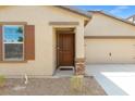 Close-up of a home's front door with a stone pillar and desert landscaping at 13 Deseo Ct, North Las Vegas, NV 89031