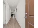 Bright hallway with light wood floors and access to multiple rooms at 13 Deseo Ct, North Las Vegas, NV 89031
