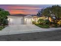 Charming single-story home featuring a three-car garage, desert landscaping, and a tile roof at 1805 Prichard Ave, Henderson, NV 89052