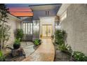Beautiful desert home featuring double doors, a landscaped walkway, and custom shutters at 1805 Prichard Ave, Henderson, NV 89052
