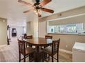 Comfortable dining area adjacent to the living room with hard wood floors and a rustic ceiling fan at 2080 Karen Ave # 34, Las Vegas, NV 89169