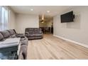 Inviting living room featuring new light wood floors, modern paint, and neutral-toned couches at 2080 Karen Ave # 34, Las Vegas, NV 89169