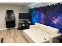 Cozy living room with unique fireplace, TV, and comfortable white convertible sofa at 2080 Karen Ave # 34, Las Vegas, NV 89169