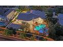 Aerial view showcasing a beautiful home with a pool, lush landscaping, and a covered patio at 2208 Point Rock Ln, Las Vegas, NV 89134