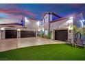 Spacious three-car garage with an extended driveway and artificial turf, ideal for car enthusiasts at 2208 Point Rock Ln, Las Vegas, NV 89134