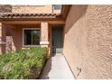 View of the front door and entryway with a small garden and walkway at 2532 Bechamel Pl, Henderson, NV 89044
