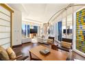 Bright living room featuring a modern sofa, hardwood floors, and large windows with city views at 3750 Las Vegas Blvd # 2407, Las Vegas, NV 89158