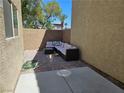 Enclosed backyard patio featuring brick pavers and outdoor sectional seating at 4256 Perfect Drift St, Las Vegas, NV 89129