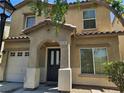 Close up on the front exterior of the home featuring a covered front porch and a two car garage at 4256 Perfect Drift St, Las Vegas, NV 89129